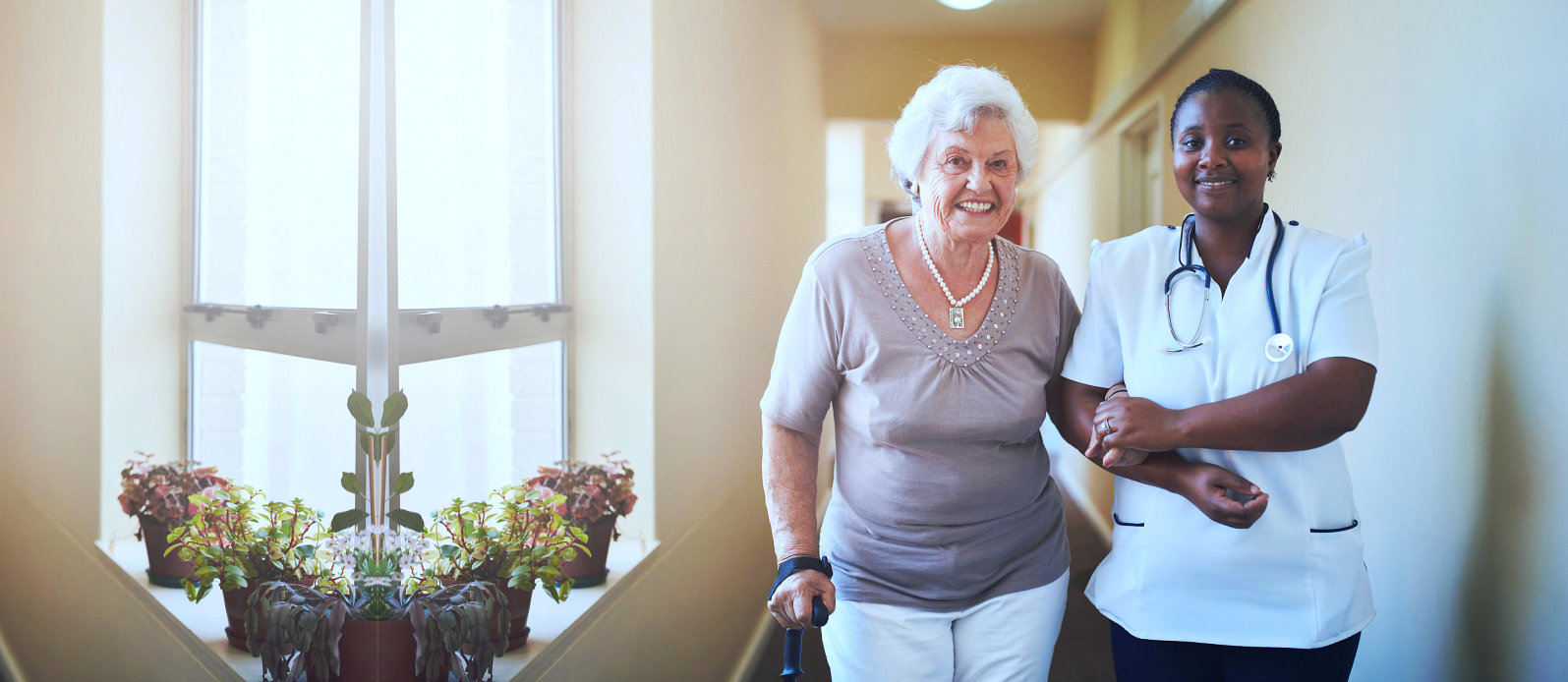 caregiver and senior woman walking