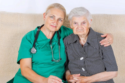 senior nurse hugging senior woman