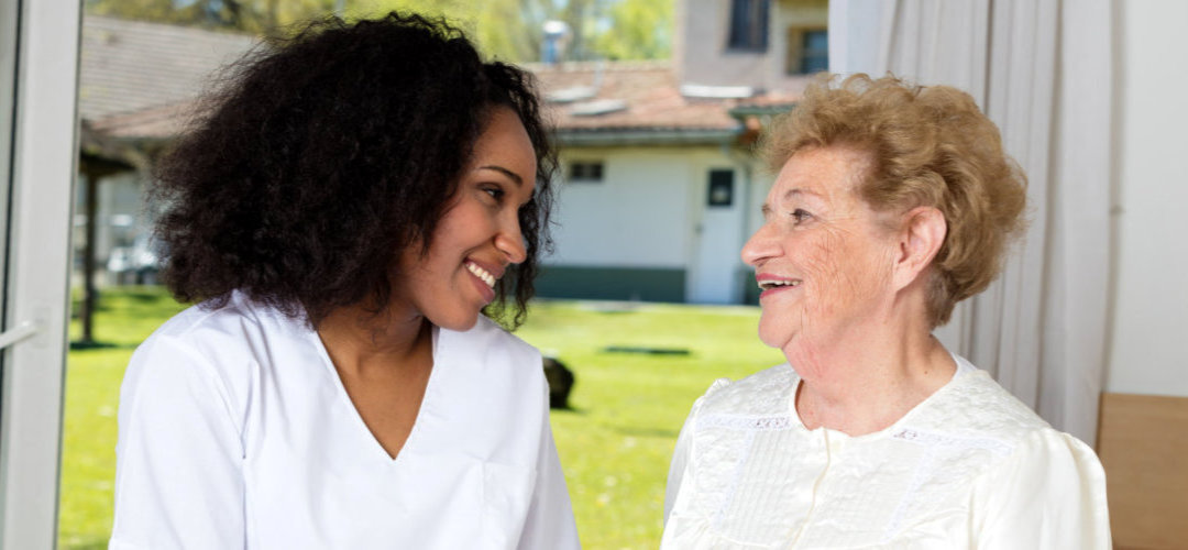 caregiver and senior woman talking indoor